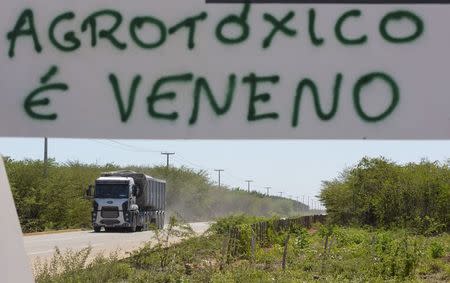 A truck moves near a sign that reads "Pesticides are poison" in Limoeiro do Norte, in Ceara state, January 15, 2015. REUTERS/Davi Pinheiro