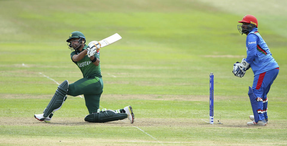 Pakistan's Babar Azam, left, bats as Afghanistan's Mohammad Shahzad watches during the Cricket World Cup Warm up match at The Bristol County Ground in Bristol, England Friday May 24, 2019. (Nigel French/PA via AP)