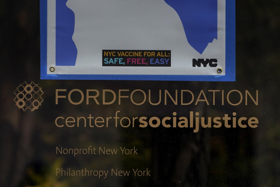 A sign is displayed on a window of the Ford Foundation Building in New York, Friday, Feb. 19, 2021. The foundation is one of nine grant makers that have issued a total of $3 billion in debt since June to cover increases in their grant making. (AP Photo/Seth Wenig)