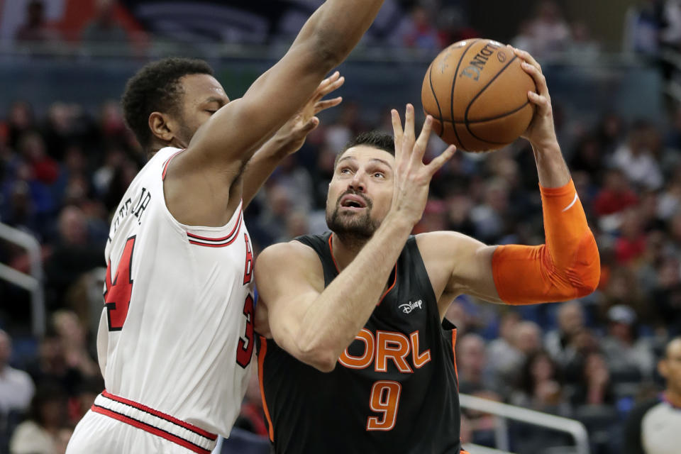 Orlando Magic center Nikola Vucevic (9) goes up for a shot against Chicago Bulls center Wendell Carter Jr. during the second half of an NBA basketball game, Monday, Dec. 23, 2019, in Orlando, Fla. (AP Photo/John Raoux)