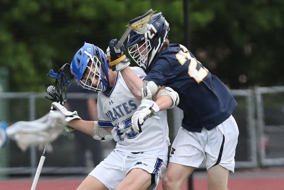 From right, Pelham's Nick Loria (27) puts pressure on Pearl River's Nicholas Paletta (15) during the boys lacrosse Section 1 Class B championship game at Lakeland High School in Shrub Oak May 26, 2022. Pelham won the game 14-6.