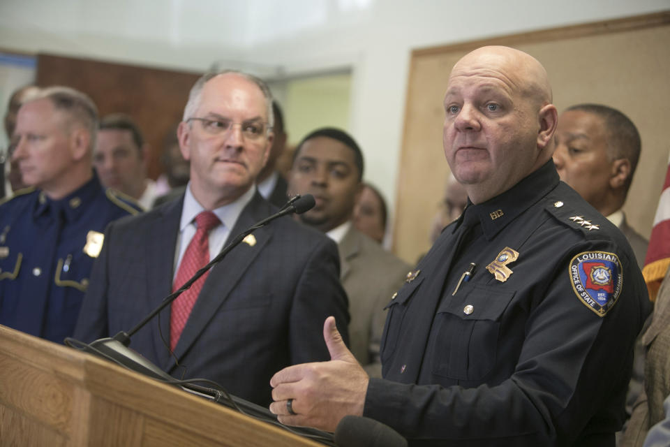 Louisiana State Fire Marshal H. "Butch" Browning speaks as Louisiana Gov. John Bel Edwards looks on during a press conference on the arrest of a suspect Holden Matthews for the arson of three churches in Opelousas, La., Thursday, April 11, 2019. (AP Photo/Lee Celano)