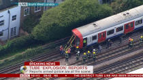 <p>Fire crews carefully investigate the Tube carriage where the blast took place. (PA/BBC News) </p>