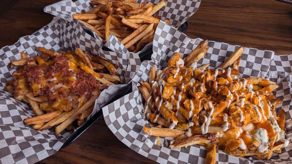 Buffalo chicken fries, left, chicken bacon ranch fries, right, and regular fries at Brewvino in Dover Township June 26, 2024.