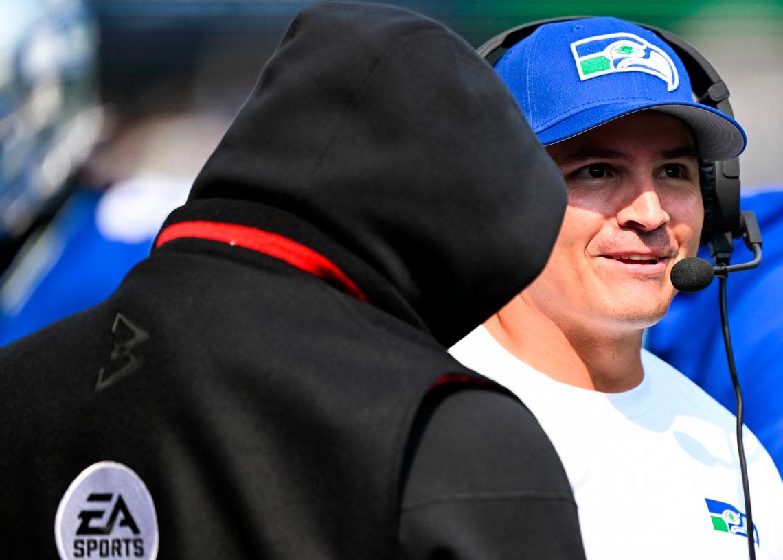 Seattle Seahawks head coach Mike Macdonald talks with former Seahawk running back Marshawn Lynch during the first quarter of the game against the Denver Broncos at Lumen Field, on Sunday, Sept. 8, 2024, in Seattle, Wash.