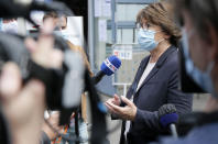 Current socialist Lille mayor and candidate in the second round of the municipal elections, Martine Aubry speaks with journalists before casting her vote, Sunday, June 28, 2020, in Lille, northern France. France is holding the second round of municipal elections in 5,000 towns and cities Sunday that were postponed due to the country's coronavirus outbreak.(AP Photo/Michel Spingler)