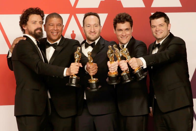 Left to right, Bob Persichetti, Peter Ramsey, Rodney Rothman, Phil Lord and Christopher Miller, winners of Best Animated Feature Film for "Spider-Man: Into the Spider-Verse," appear backstage with their Oscar during the Academy Awards in 2019. File Photo by John Angelillo/UPI