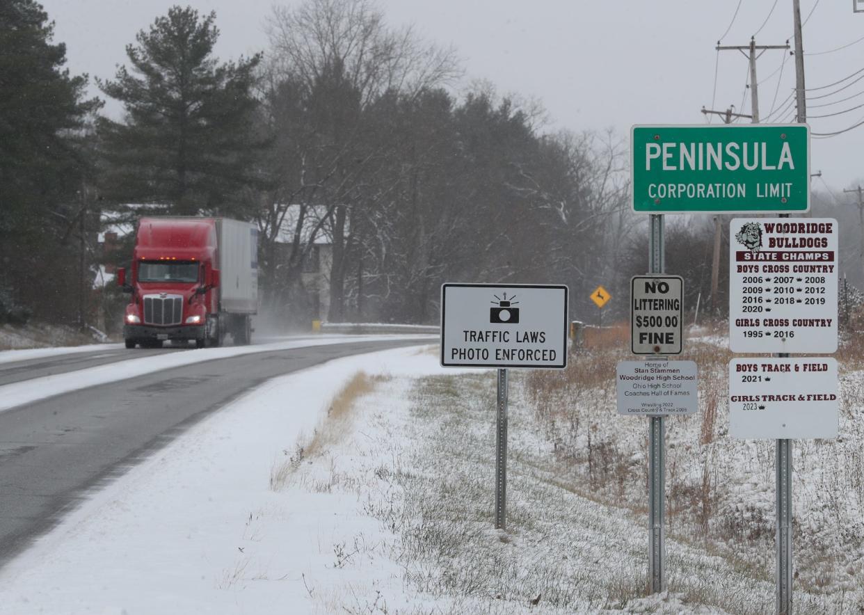 A photo enforcement sign pictured on the westbound side of Ohio State Route 303 as a truck heads east in Peninsula on Tuesday, Nov. 28. 2023.