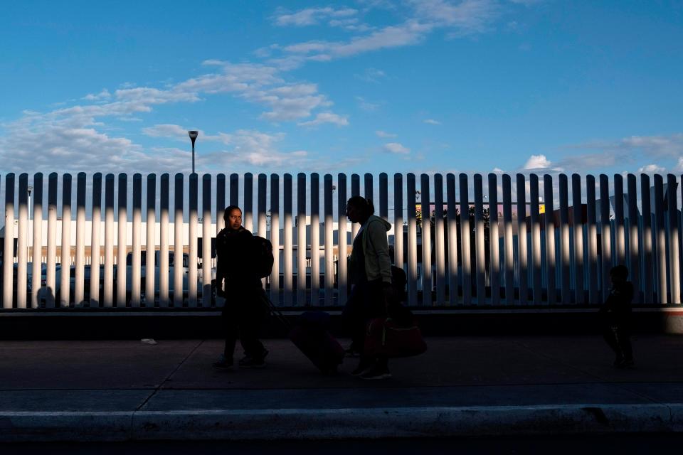 Asylum seekers wait for their turn to cross  to the United States at El Chaparral crossing port on the US/Mexico Border in Tijuana, Baja California state, Mexico, on February 29, 2020. 