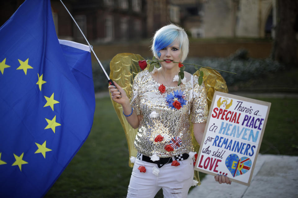 Remain in the European Union supporter Madeleina Kay, aged 24 from Sheffield, poses for photographs opposite the Houses of Parliament in London, Thursday, Feb. 14, 2019. Madeleina believes stopping Brexit, having another referendum where everyone abides by the law and educating people on the role the EU plays in Britain would be the best way forward. Britain voted to leave Europe in a referendum more than two years ago, but Parliament has been unable to agree on a withdrawal arrangement, prompting some calls for a delay or even a cancellation of the split. (AP Photo/Matt Dunham)