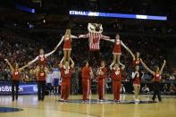 Wisconsin cheerleaders perform during the second half of a second-round game between the Wisconsin and the American in the NCAA college basketball tournament Thursday, March 20, 2014, in Milwaukee. (AP Photo/Jeffrey Phelps)