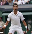 Serbia's Novak Djokovic celebrates after scoring a point against Canada's Denis Shapovalov during the men's singles semifinals match on day eleven of the Wimbledon Tennis Championships in London, Friday, July 9, 2021. (AP Photo/Alberto Pezzali)