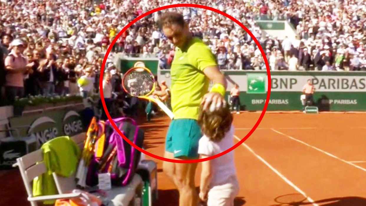 Rafa Nadal (pictured middle) greets a young child at the French Open.