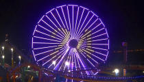 This photo provided by Pacific Park on the Santa Monica, Calif., Pier shows their Ferris wheel in Los Angeles Lakers purple and gold colors with Kobe Bryant's No. 24 in honor of the former Lakers star who died with several others in a helicopter crash in Southern California on Sunday, Jan. 26, 2020. (Pacific Park via AP)