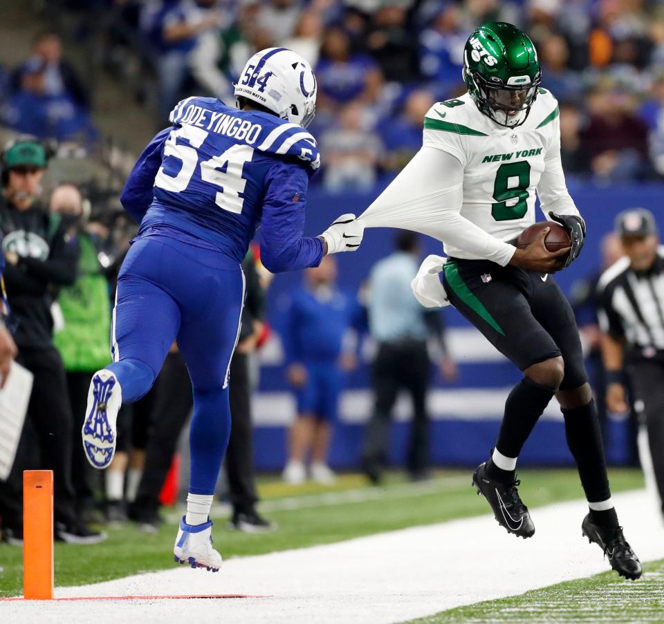 Indianapolis Colts defensive end Dayo Odeyingbo (54) pulls New Yorks Jets quarterback Josh Johnson (9) out of bounds Thursday, Nov. 4, 2021, during a game against the New York Jets at Lucas Oil Stadium in Indianapolis.