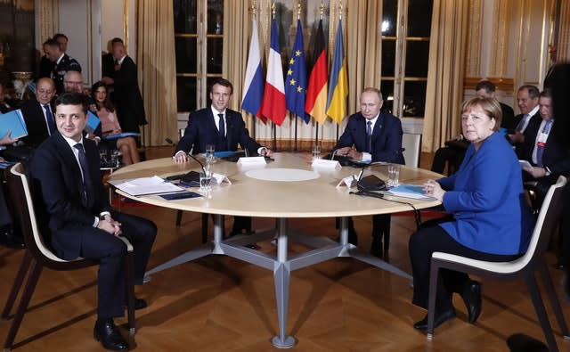 The four world leaders sit around a table