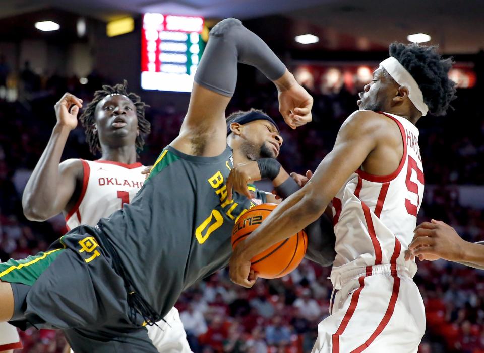 Oklahoma's Elijah Harkless (55) fights Baylor's Flo Thamba (0) for a rebound in the firs hafl during the men's college game between the Oklahoma Sooners and the Baylor Bears at the Lloyd Noble Center in Norman, Okla., Saturday, Jan. 22, 2022. 