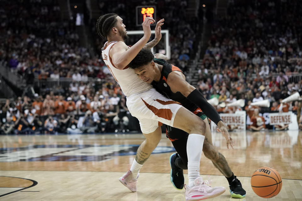 Miami guard Jordan Miller drives to the basket past Texas forward Timmy Allen in the second half of an Elite 8 college basketball game in the Midwest Regional of the NCAA Tournament Sunday, March 26, 2023, in Kansas City, Mo. (AP Photo/Charlie Riedel)