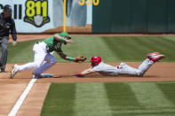 Oakland Athletics third baseman Jace Peterson, left, tags out Cincinnati Reds' Spencer Steer after a failed steel attempt during the first inning of a baseball game in Oakland, Calif., Saturday, April 29, 2023. (AP Photo/John Hefti)