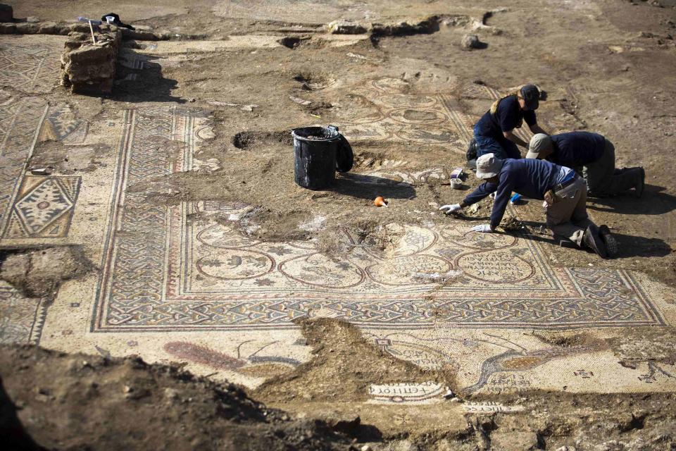 Archaeologists from Israel's Antiquities Authority work at an excavation site where a mosaic floor of an ancient Byzantine church was uncovered near Kiryat Gat