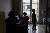 Afghan lawyer Bibi Chaman Hafizi and her children Arsheya and Diana are seen in the living room of their apartment in Athens