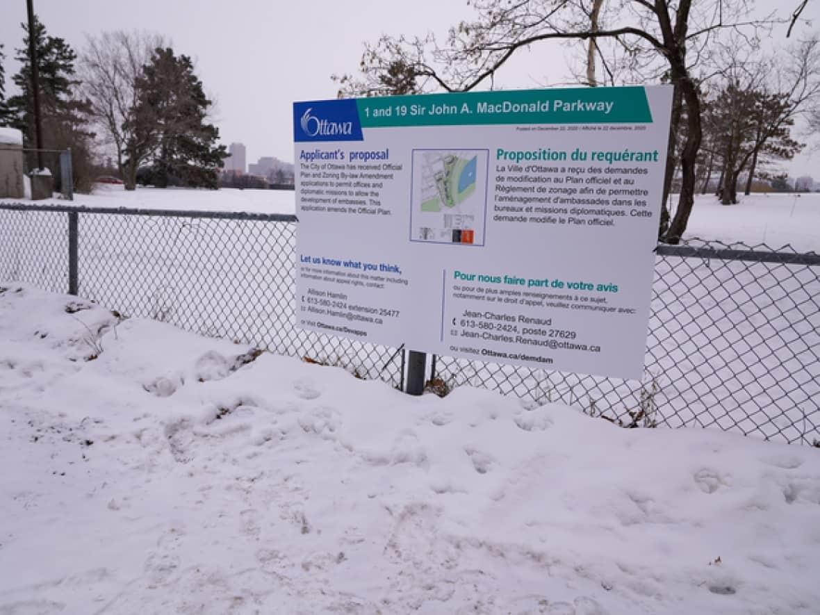 A sign signals the National Capital Commission's desire to build several embassies on greenspace in Ottawa's Mechanicsville neighbourhood. A new settlement means the legal fight over the controversial project is likely over. (Francis Ferland/CBC - image credit)