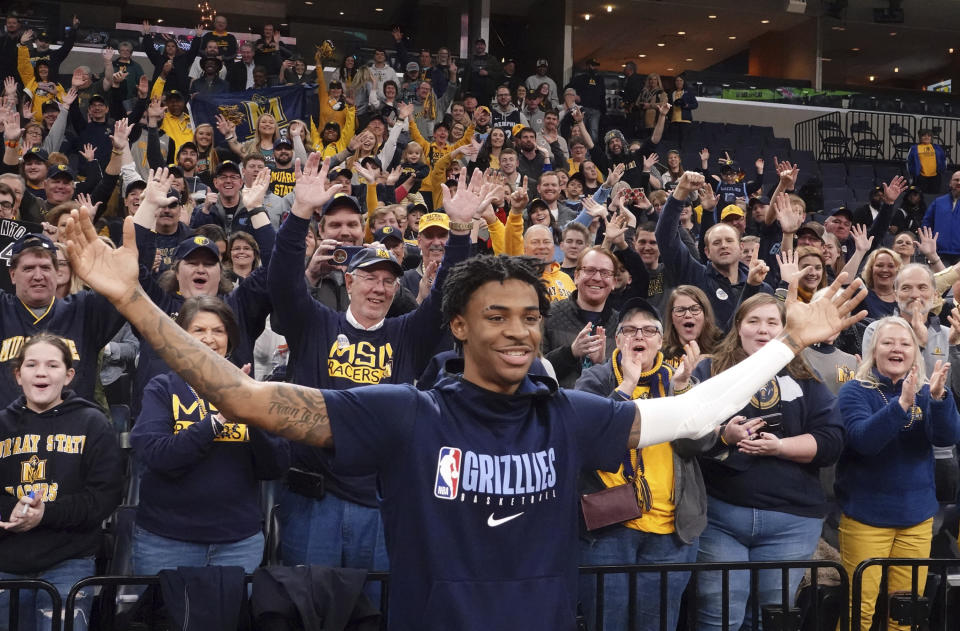 Murray State fans cheer for Memphis Grizzlies rookie Ja Morant, foreground, before the Grizzlies' NBA basketball game against the Cleveland Cavaliers on Friday, Jan. 17, 2020, in Memphis, Tenn. (AP Photo/Karen Pulfer Focht)