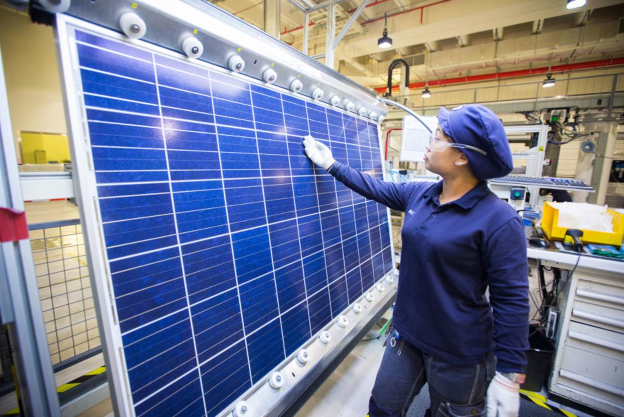 An employee inspects a solar panel for faults on the module production line at the REC Solar ASA manufacturing facility in Singapore, on Friday, Sept. 5, 2014. Photographer: Nicky Loh/Bloomberg