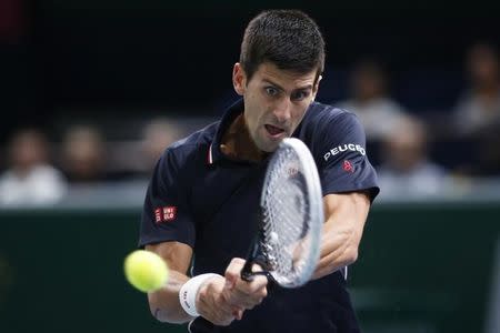 Novak Djokovic of Serbia returns a shot during his men's singles semi-final tennis match against Kei Nishikori of Japan at the Paris Masters tennis tournament at the Bercy sports hall in Paris, November 1, 2014. REUTERS/Benoit Tessier