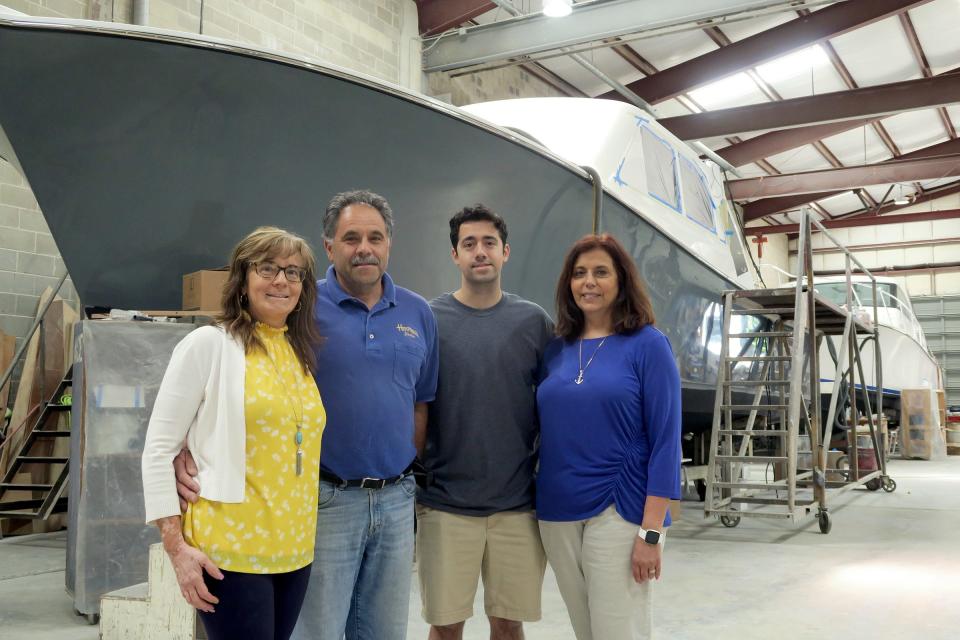 The family behind Henrques Yachts (left to right):  Natalia Henriques-Costa, Manuel Costa, Michael Costa and Maria Henriques-DeMers gather for a photo in front of yachts under construction at their Berkeley Township facility Monday, June 6, 2022.  The Shore's boating industry would be taking advantage of a huge demand in new boaters that took off during the pandemic, if only it could solve the backlog in the supply chain.
