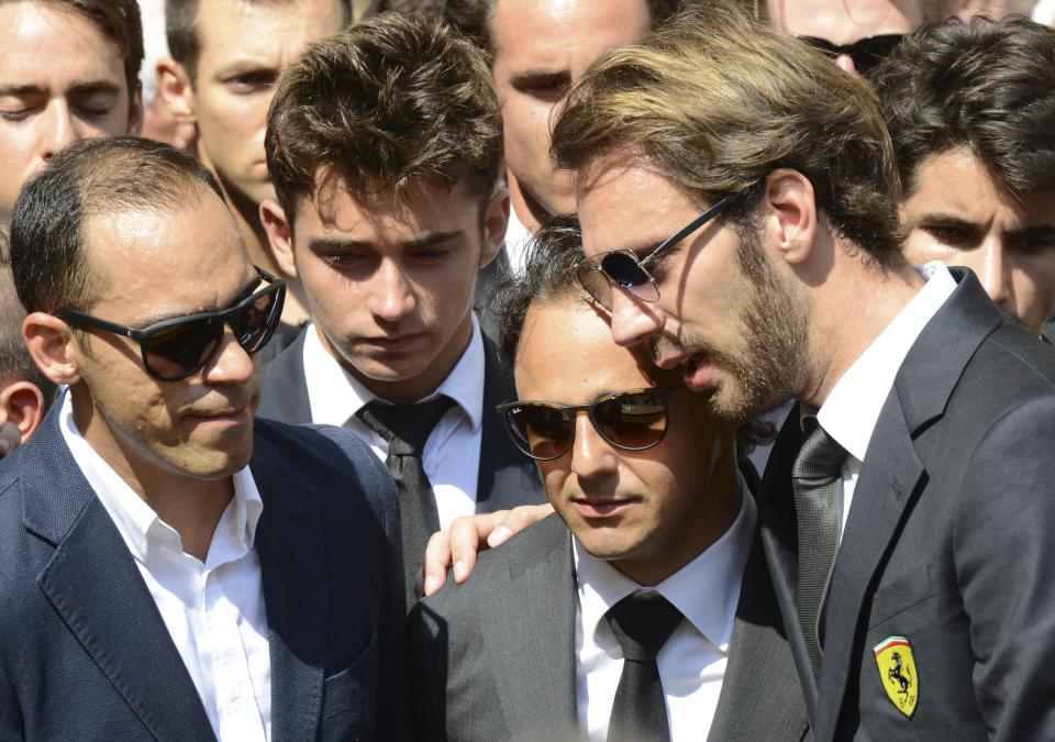 Formula One drivers Jean-Eric Vergne (R) and Felipe Massa C), friends and relatives gather around the coffin of late Marussia F1 driver Jules Bianchi during the funeral ceremony at the Sainte Reparate Cathedral in Nice, France, July 21, 2015. Bianchi, 25, died in hospital in Nice on Friday, nine months after his crash at Suzuka in Japan and without regaining consciousness. REUTERS/Jean-Pierre Amet