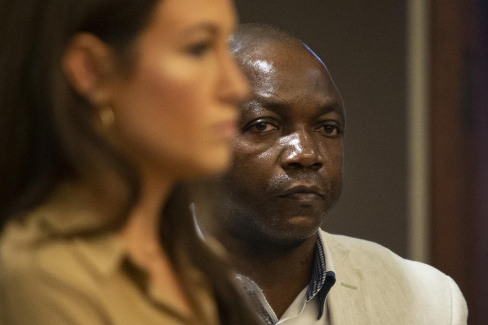 FILE - Patrick Lyoya's father, Peter Lyoya, listens during a hearing for former Grand Rapids police officer Christopher Schurr at the Kent County Courthouse, Oct. 31, 2022, in Grand Rapids, Mich. Lawyers for the former Michigan police officer are asking the state appeals court to throw out a murder charge in the killing of a Black motorist in 2022. The court is scheduled to hear arguments Wednesday, Sept. 6, 2023, in the case against Schurr, who shot Patrick Lyoya in the back of the head after a morning traffic stop in Grand Rapids turned into a short foot chase and vigorous struggle. (Cory Morse/MLive.com/The Grand Rapids Press via AP, Pool, File)