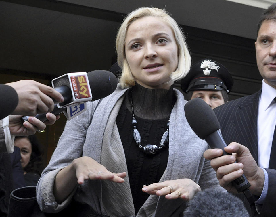 Domnica Cemortan, from Moldova, leaves the converted Teatro Moderno theater after testifying in a hearing in the trial of Captain Francesco Schettino, in Grosseto, Italy, Tuesday, Oct. 29, 2013. The Moldovan dancer, who was on the bridge when the Costa Concordia crashed into the reef, has testified she was the lover of captain Schettino. The captain of the wrecked Costa Concordia is charged with manslaughter, causing the shipwreck and abandoning ship before the luxury cruise liner's 4,200 passengers and crew could be evacuated on Jan. 13, 2012 when the ship collided with a reef off the Tuscan island of Giglio, killing 32 people. (AP Photo/Giacomo Aprili)