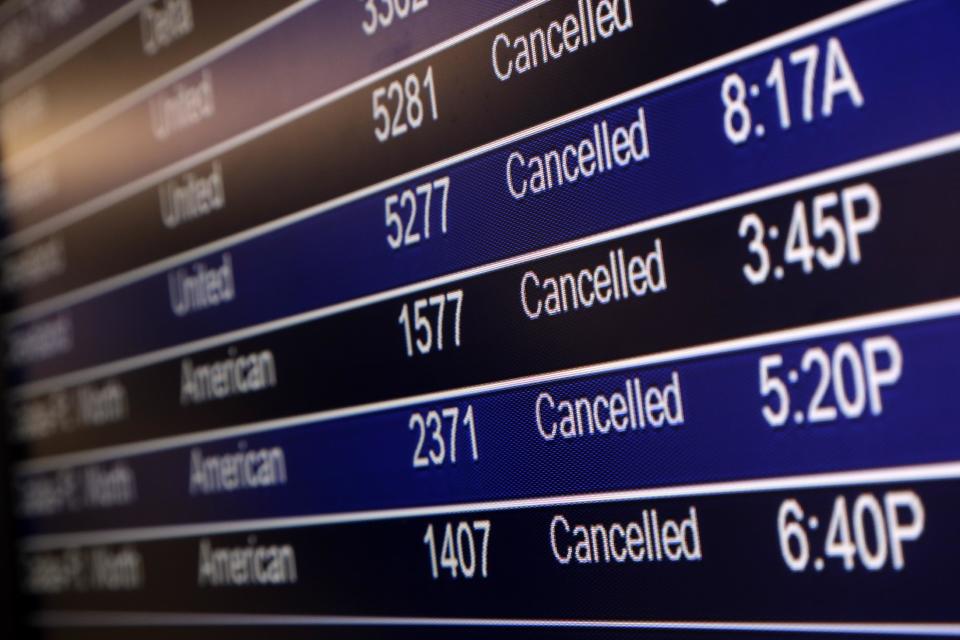 In this Sunday, Jan. 5, 2014, file photo, a departures board shows canceled flights at Lambert-St. Louis International Airport in St. Louis. A series of winter storms have led airlines to cancel more than 33,000 flights during the first three weeks of this year. That's more cancellations than in January 2013 and January 2012 combined, according to masFlight, a data and software company specializing in airline operations. (AP Photo/Jeff Roberson, File)
