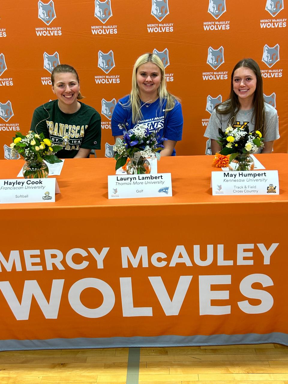 Three Mercy McAuley High School athletes signed their letters of intent to play college sports April 17. They are, from left, Hayley Cook, Franciscan University softball; Lauryn Lambert, Thomas More University golf; and May Humpert Kennesaw University track & field/cross country.