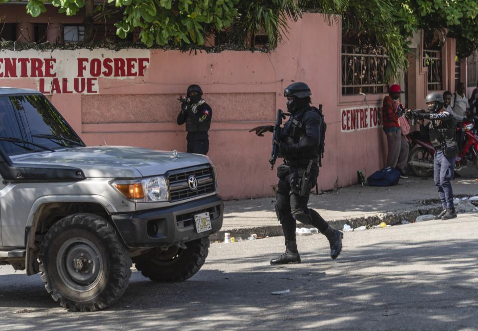 Police stop at a car to inspect in Port-au-Prince, Haiti, Monday, April 22, 2024. (AP Photo/Ramon Espinosa)