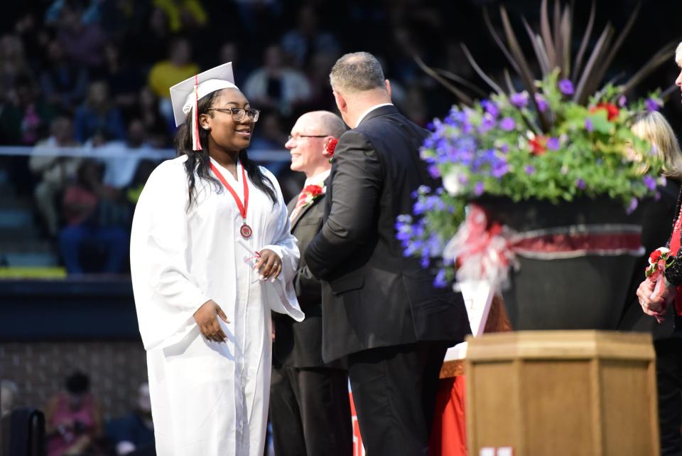 Graduating seniors walk on to the stage to be handed their diplomas during the Port Huron High School commencement ceremony at McMorran Arena in Port Huron on Wednesday, June 8, 2022.