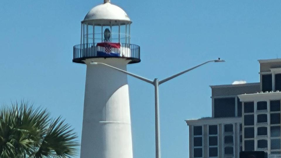 The Croatian flag flies atop the Biloxi Lighthouse in March 2022, when the Croatian Consulate General to the United States visited the city, where many people of Croatian descent live.