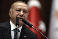 Turkey's President Recep Tayyip Erdogan addresses his ruling party MPs, in Ankara, Turkey, Tuesday, June 25, 2019, two days after Ekrem Imamoglu, the candidate of the secular opposition Republican People's Party, won the election for mayor of Istanbul. Erdogan addressed his AK Party's weekly meeting, the first time he speaks since the Istanbul mayoral election Sunday, which was a big setback for him and his party. (AP Photo/Burhan Ozbilici)