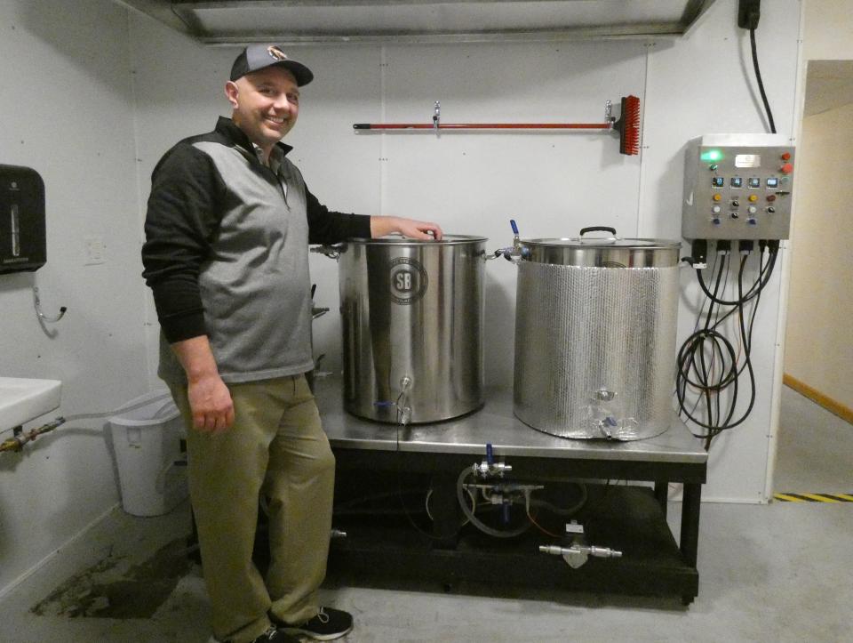 Mark Burke shows off the brew kettles at Arrogant Goat Brewing, 125A E. Rensselaer St.