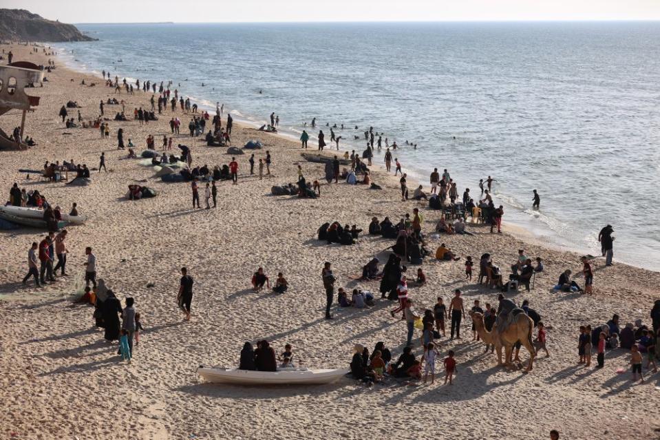 Displaced Palestinians flee to the seashore from the high temperatures inside the displacement tents on April 17, 2024.