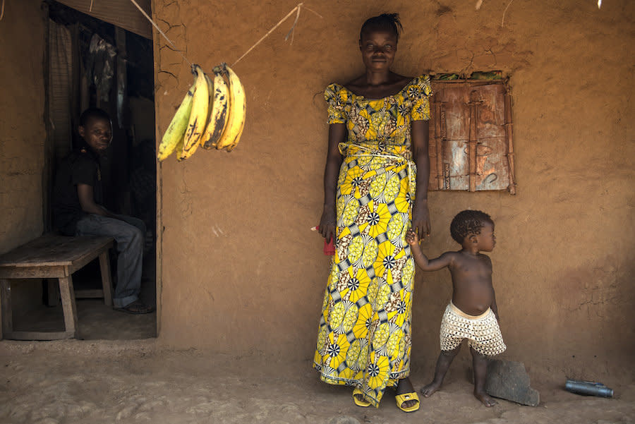 Uma residents stand outside a small clinic in the village. (Photo: Neil Brandvold/DNDi)