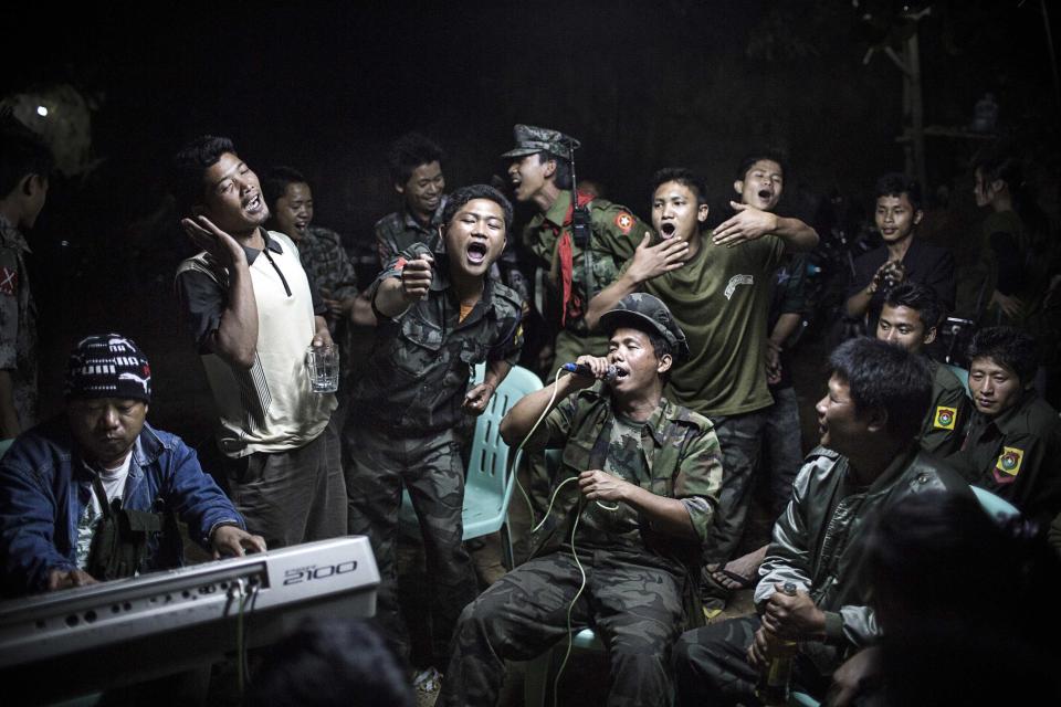 Julius Schrank, a German photographer working for De Volkskrant won 1st Prize Daily Life Single category of the 2014 World Press Photo contest with this picture of Kachin Independence Army fighters drinking and celebrating at a funeral of one of their commanders who died the day before, in Burma, taken March 15, 2013. The prize-winning entries of the World Press Photo Contest 2014, the world's largest annual press photography contest, were announced February 14, 2014. REUTERS/Julius Schrank/World Press Photo Handout via Reuters