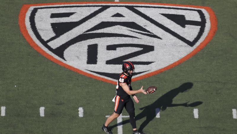 Oregon State long snapper Dylan Black (48) warms up near a Pac-12 logo on the field at Reser Stadium before a game against UC Davis on Sept. 9, 2023, in Corvallis, Ore.