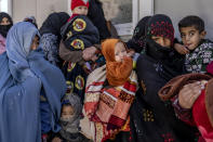 Mothers along with babies who suffer from malnutrition wait to receive help and check-up at a clinic that run by the WFP, in Kabul, Afghanistan, Thursday, Jan. 26, 2023. A spokesman for the U.N. food agency says malnutrition rates in Afghanistan are at record highs. Aid agencies have been providing food, education, healthcare and other critical support to people, but distribution has been severely impacted by a Taliban edict banning women from working at national and international nongovernmental groups. (AP Photo/Ebrahim Noroozi)