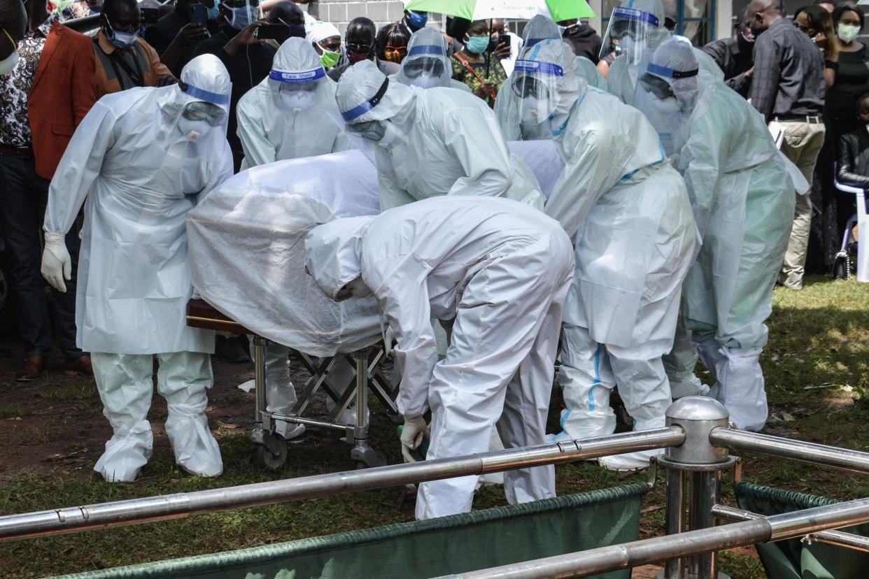 Medics carry the coffin of Dr Lugaliki – the first doctor in Kenya to die from Covid-19 – in July (AFP/Getty)