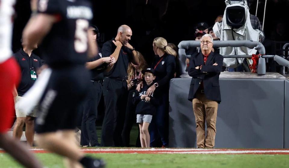 N.C. State Chancellor Randy Woodson, right, watches during the Wolfpack’s game against Louisville at Carter-Finley Stadium in Raleigh, N.C., Friday, Sept. 29, 2023.