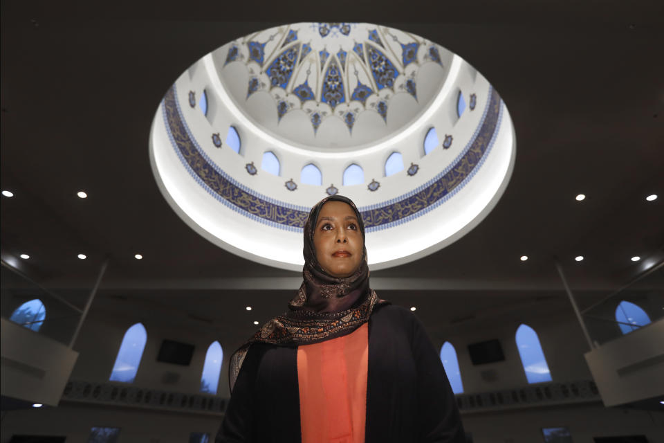 In this Monday, June 22, 2020, photo, Hind Makki, poses for a portrait at the The Prayer Center of Orland Park in Orland Park, Ill. Makki remembers how, as a young girl, she would call out others at the Islamic school she attended when she heard an Arabic word that means "slave" casually used to refer to Black people. "Maybe 85% of the time, the response I would get from people...is 'Oh, we don't mean you, we mean the Americans,'" Makki said during a virtual panel discussion on race. (AP Photo/Charles Rex Arbogast)