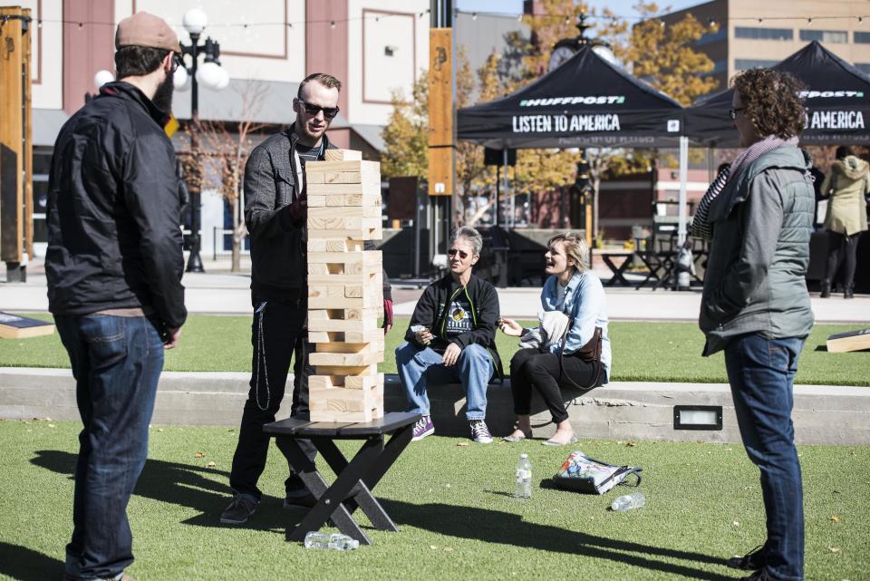 Chad Pollock, Trenton Reynolds and Mallory Pollock play a jumbo game of Jenga.