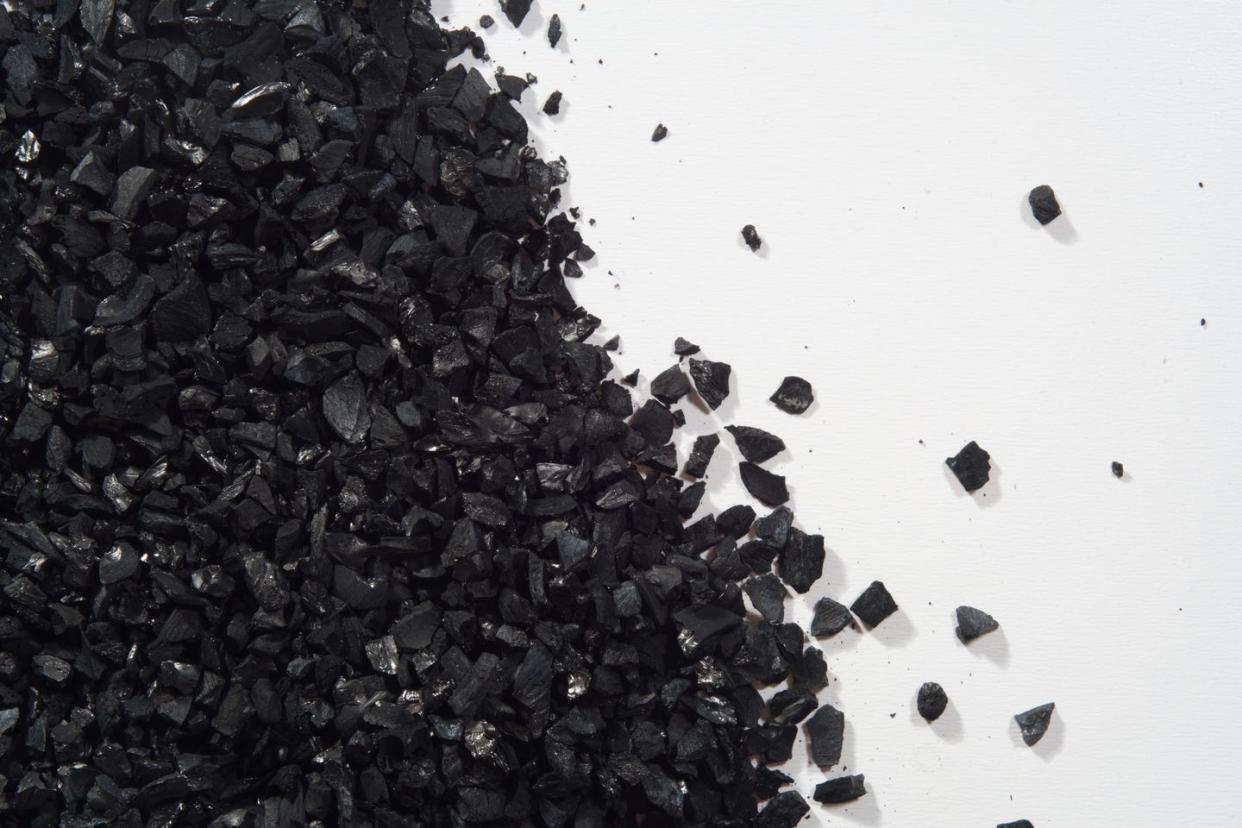 heap of activated charcoal on white background